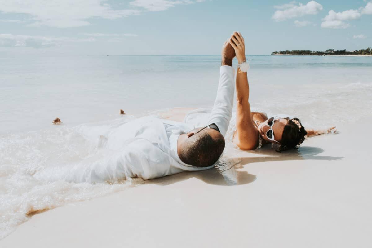 Playful Trash the Dress pose on the sand – beach wedding session Mexico