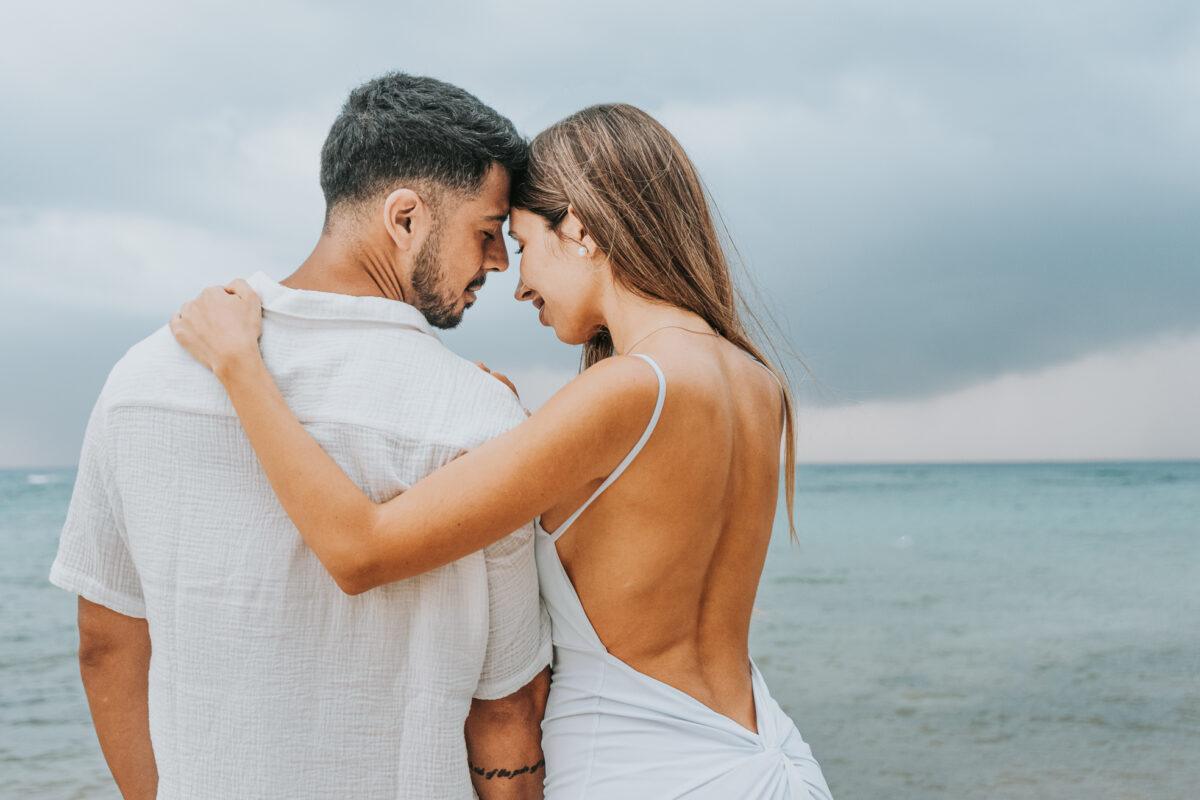 Engaged couple embracing on the beach after saying yes – Riviera Maya photography