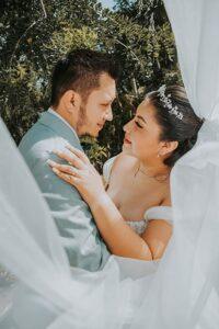 Bride and groom sharing a joyful moment on their wedding day, captured by affordable wedding photographers specializing in natural and emotional portraits