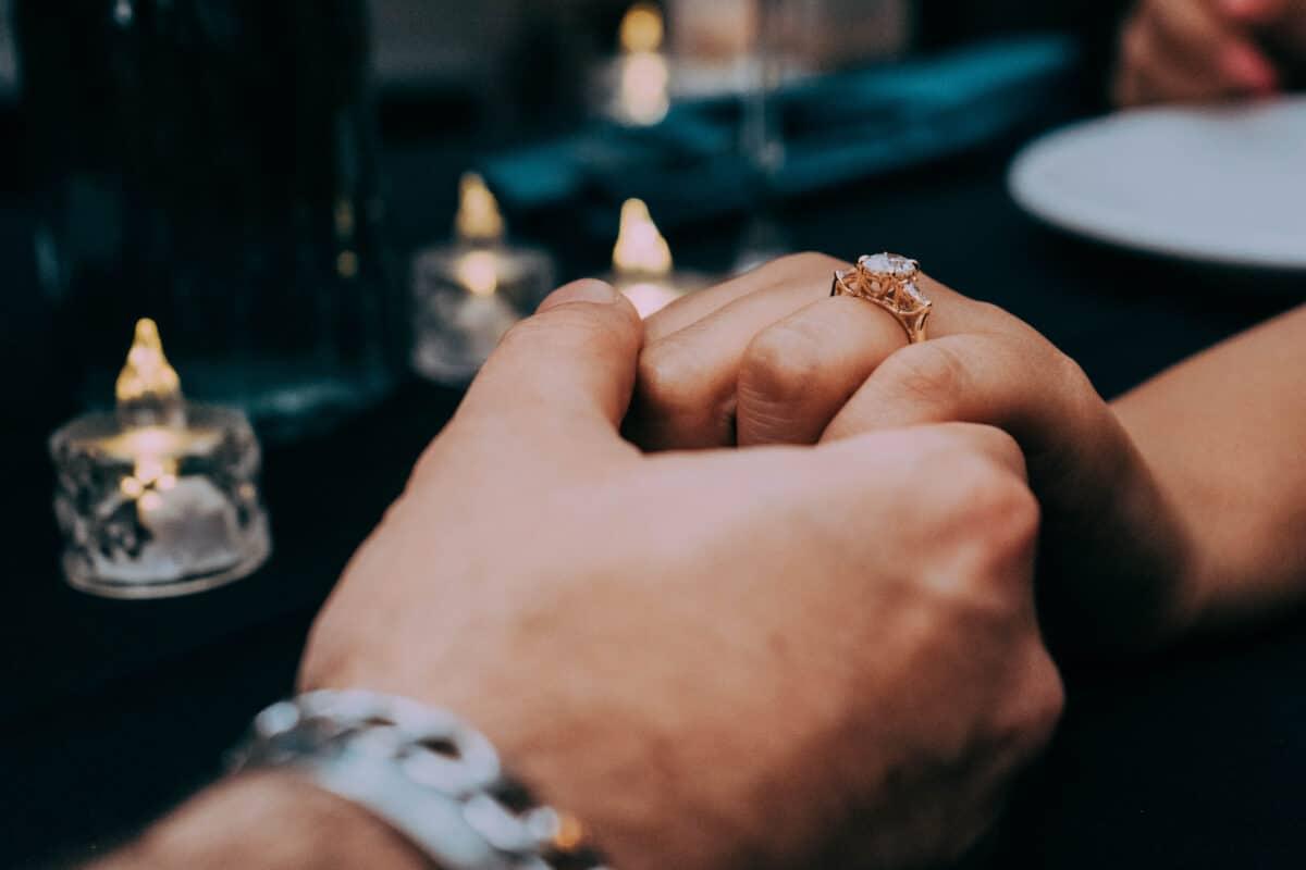 Close-up of engagement ring being placed – romantic proposal in Playa del Carmen